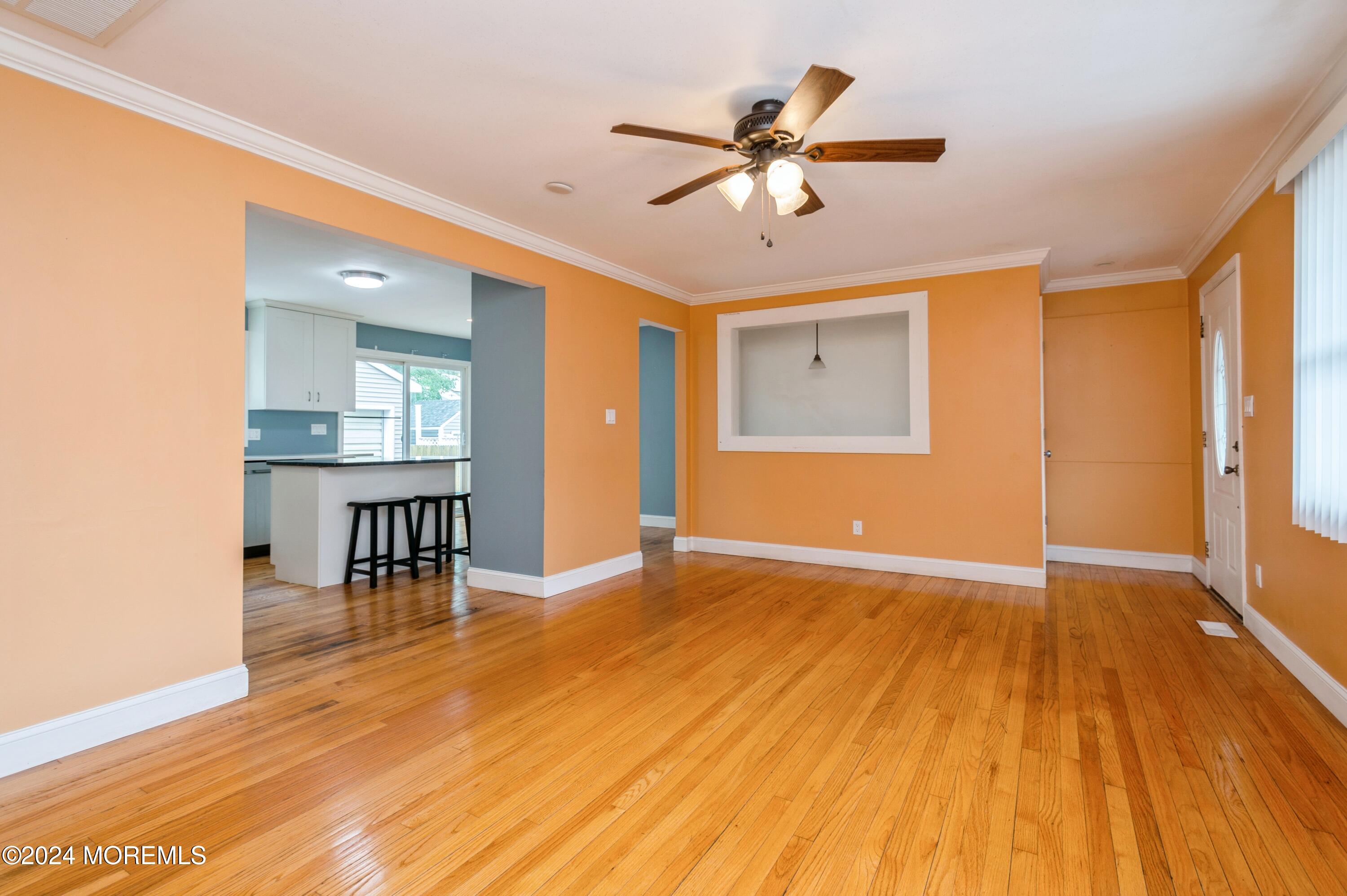 19 Holly Road Brick, NJ 08723 - Photo 4 of 16 a view of an empty room with wooden floor and a window