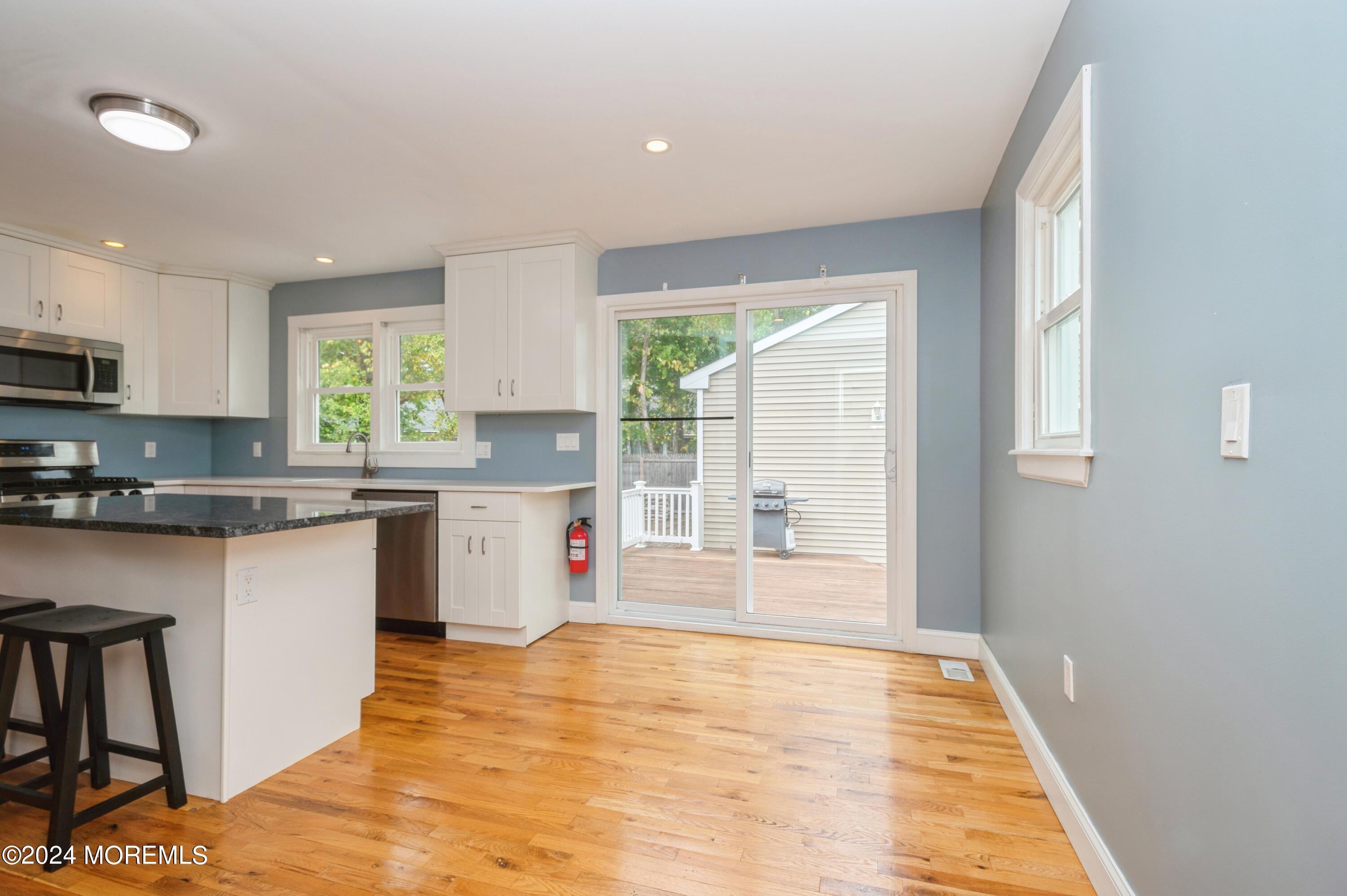 19 Holly Road Brick, NJ 08723 - Photo 7 of 16 a kitchen with stainless steel appliances granite countertop a stove a sink and a microwave