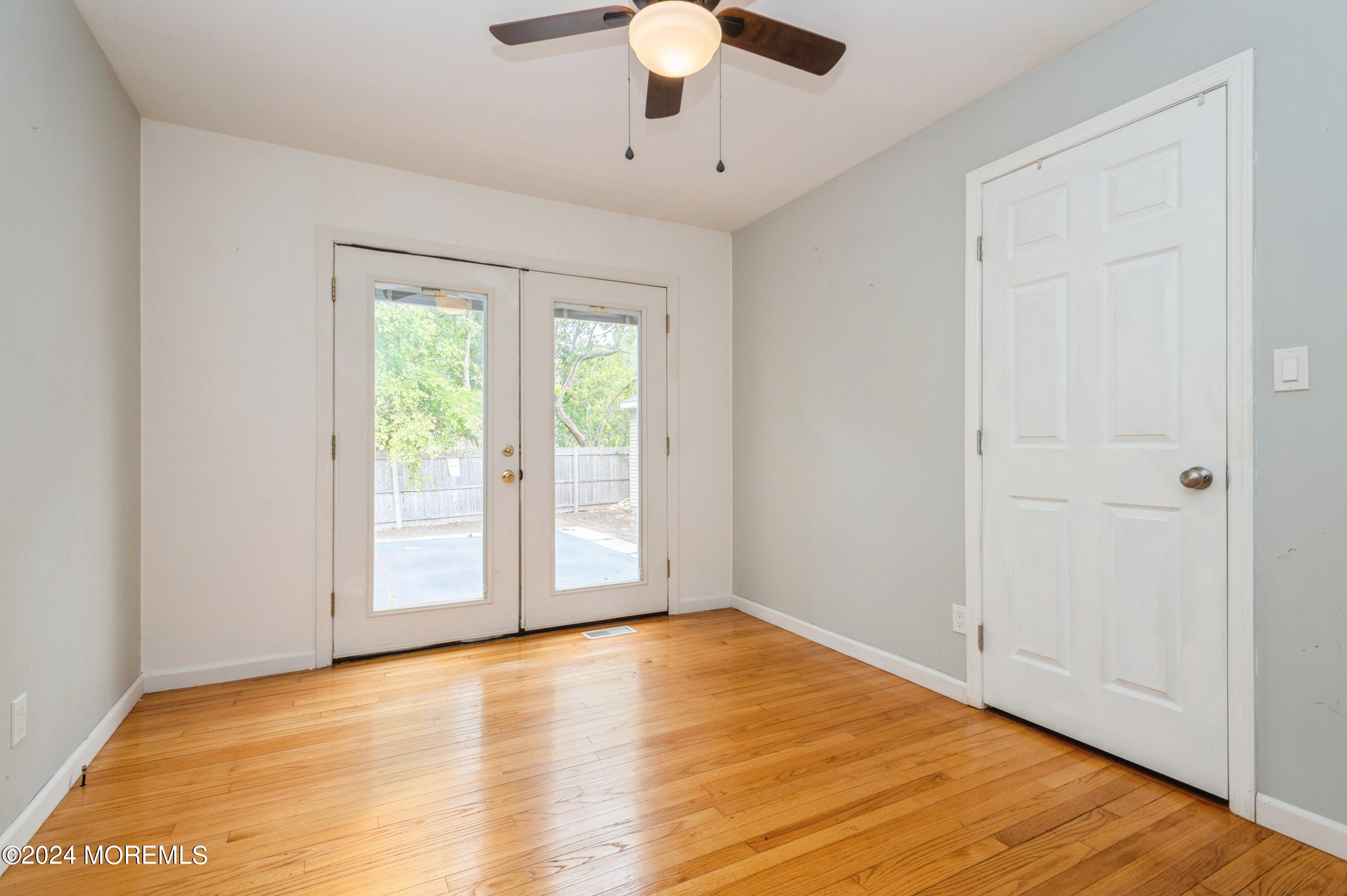 19 Holly Road Brick, NJ 08723 - Photo 8 of 16 a view of an empty room with wooden floor and a window