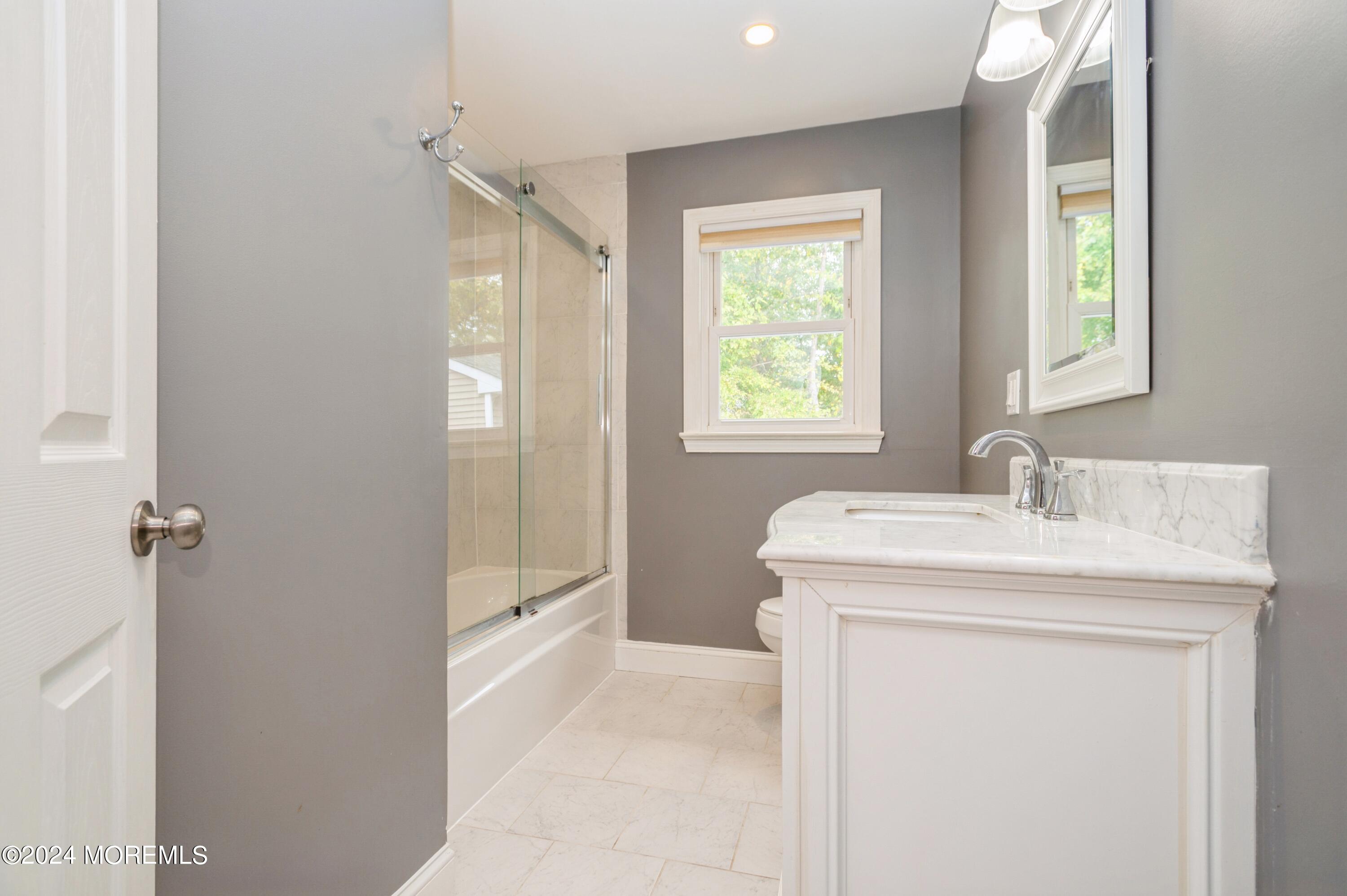 19 Holly Road Brick, NJ 08723 - Photo 9 of 16 a bathroom with a granite countertop sink a toilet and a shower