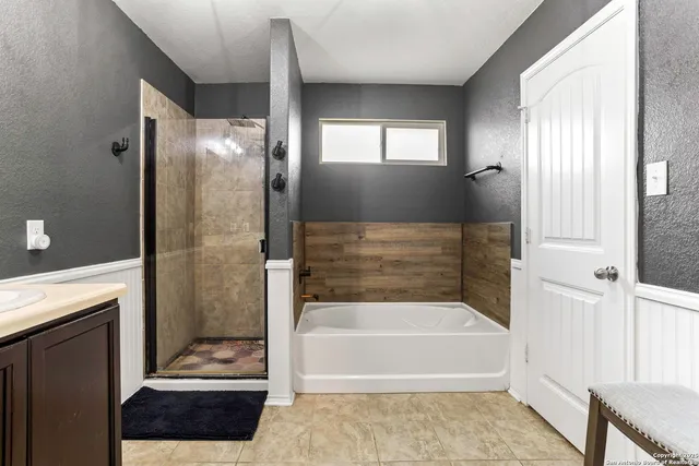 a bathroom with a bathtub and a shower
