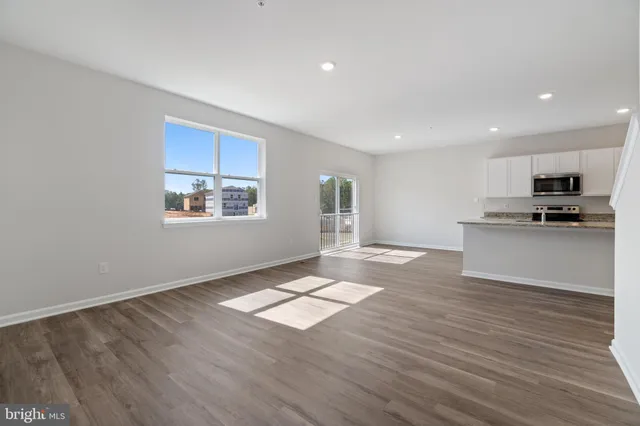 a view of kitchen with wooden floor electronic appliances and window