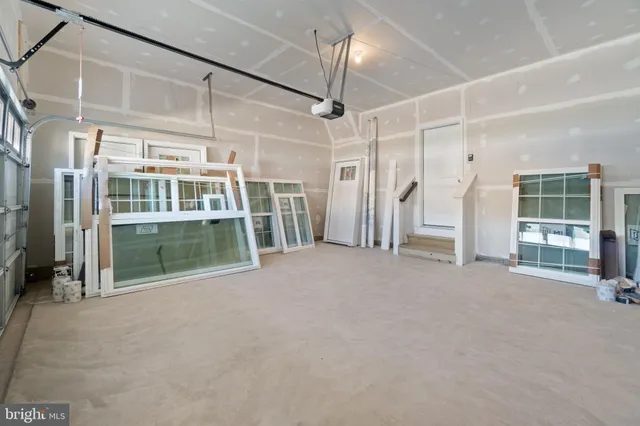 a view of a room with wooden floor and windows