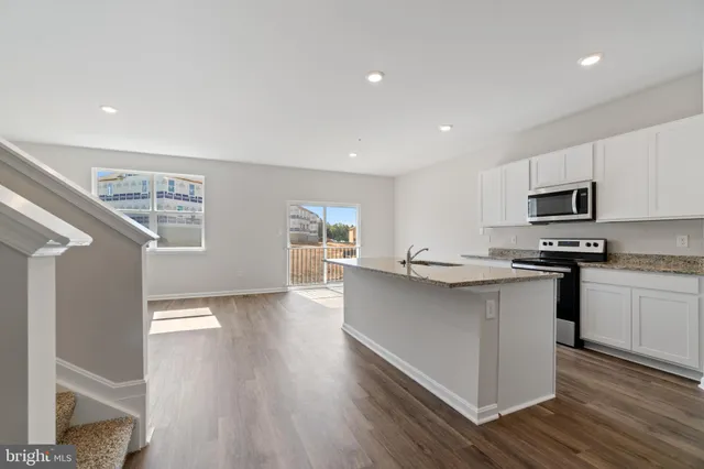 a kitchen with counter top space cabinets and appliances