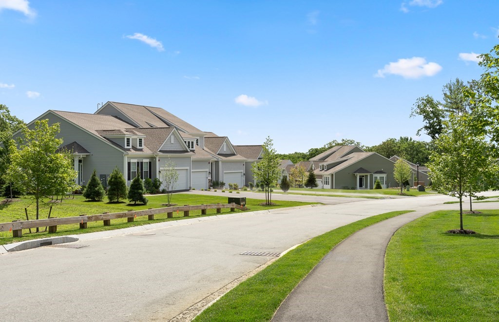 52 Sienna, Unit 47 Upton, MA 01568 - Photo 14 of 17 a view of an house with a big yard and large trees