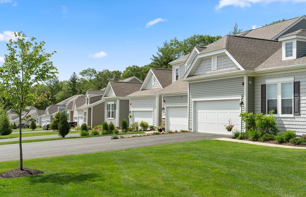 52 Sienna, Unit 47 Upton, MA 01568 - Photo 15 of 17 a front view of a house with a garden and plants