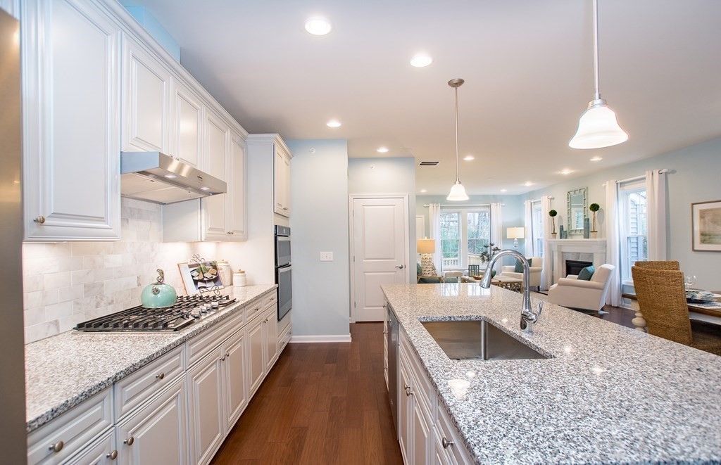 52 Sienna, Unit 47 Upton, MA 01568 - Photo 3 of 17 a large kitchen with kitchen island a large counter space a sink stainless steel appliances and cabinets