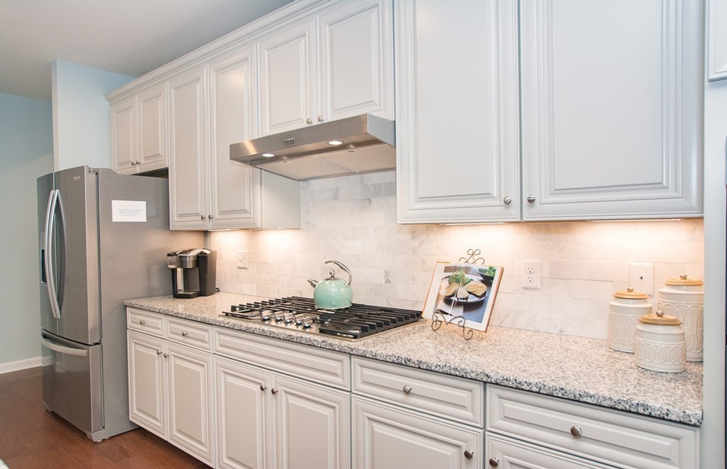 52 Sienna, Unit 47 Upton, MA 01568 - Photo 4 of 17 a kitchen with stainless steel appliances granite countertop white cabinets and a refrigerator