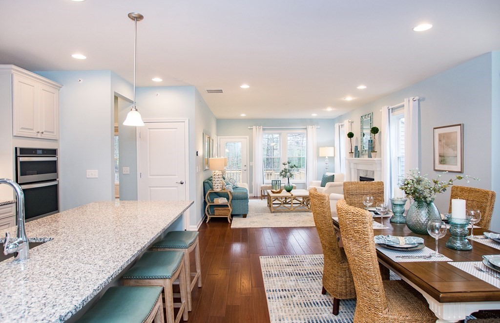 52 Sienna, Unit 47 Upton, MA 01568 - Photo 8 of 17 a large living room with stainless steel appliances kitchen island granite countertop a rug kitchen view and living room view