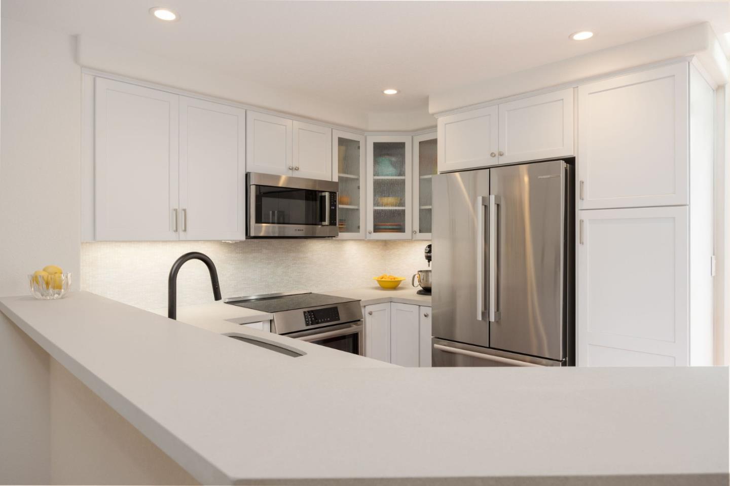 12 Patrick Way Half Moon Bay, CA 94019 - Photo 15 of 36 a kitchen with stainless steel appliances granite countertop a refrigerator a stove a sink and a microwave with wooden floor
