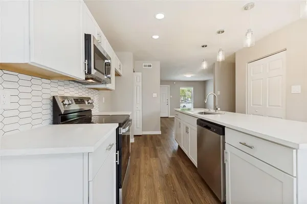 a view of kitchen and hall with wooden floor