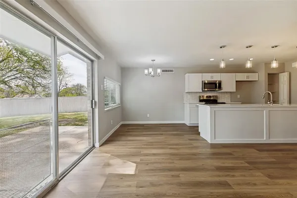 an empty room with closet and windows