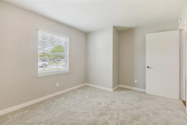 a bedroom with a bed and a large mirror