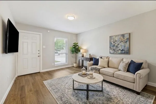 a living room with furniture and a flat screen tv