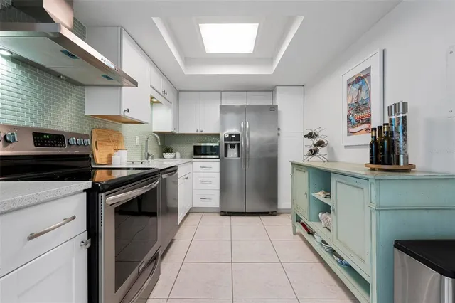 a kitchen with a sink cabinets and stainless steel appliances