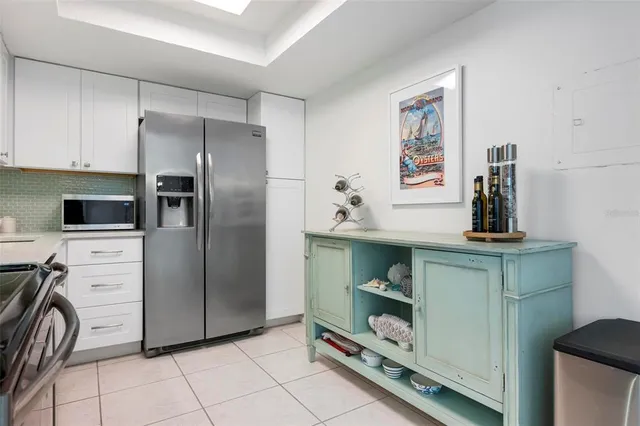 a kitchen with stainless steel appliances a refrigerator and cabinets