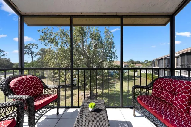 a balcony with wooden floor and outdoor seating