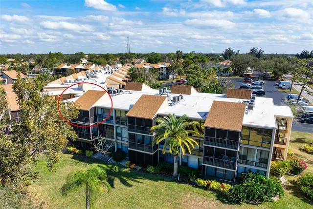 an aerial view of residential houses with city view
