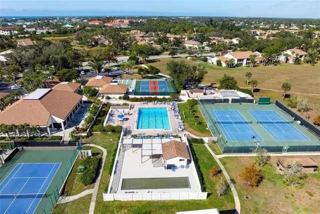an aerial view of a houses with a lake