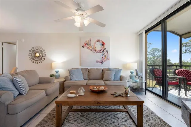 a living room with furniture a rug and a large window