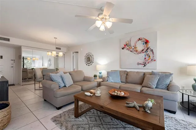 a living room with furniture a rug and a chandelier
