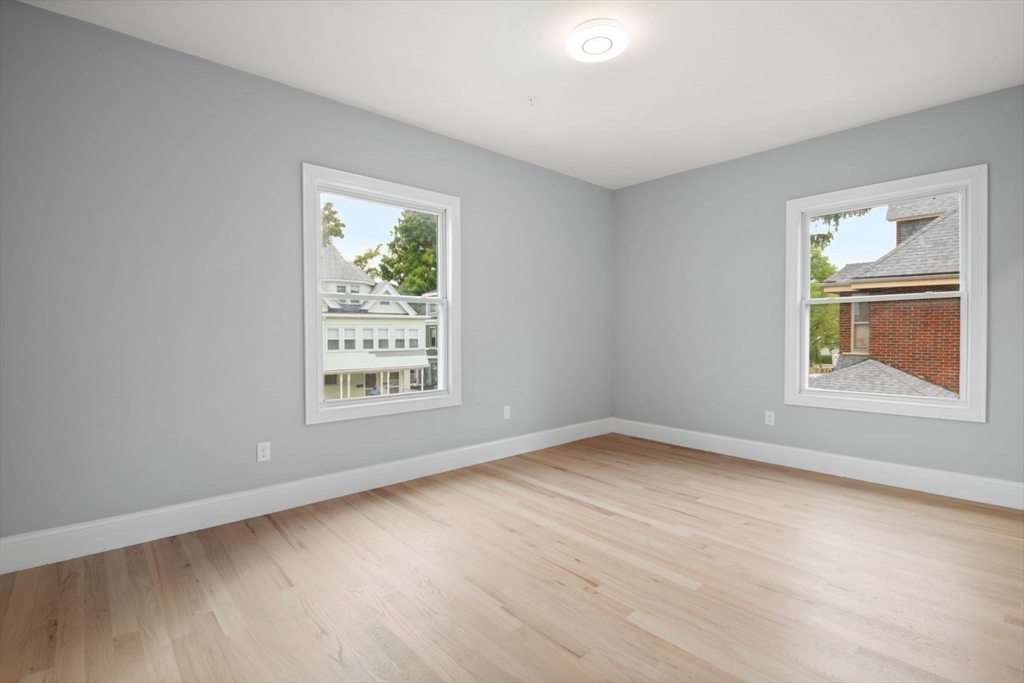 7 Waumbeck Street, Unit 2 Boston, MA 02121 - Photo 14 of 18 a view of an empty room with wooden floor and a window
