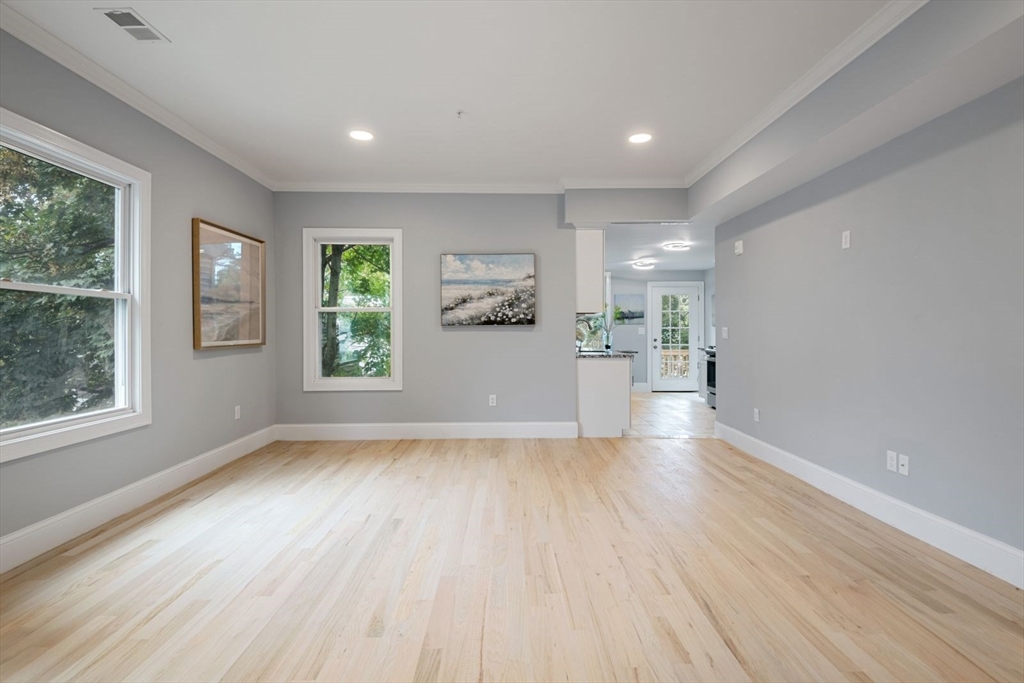 7 Waumbeck Street, Unit 2 Boston, MA 02121 - Photo 15 of 18 a view of a big room with wooden floor and windows