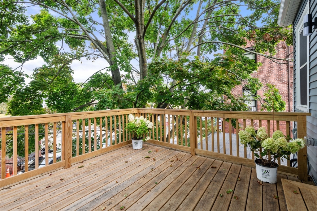 7 Waumbeck Street, Unit 2 Boston, MA 02121 - Photo 16 of 18 a view of balcony with wooden floor and fence