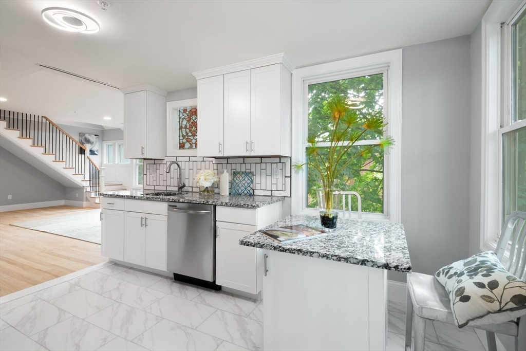 7 Waumbeck Street, Unit 2 Boston, MA 02121 - Photo 5 of 18 a kitchen with granite countertop sink and window