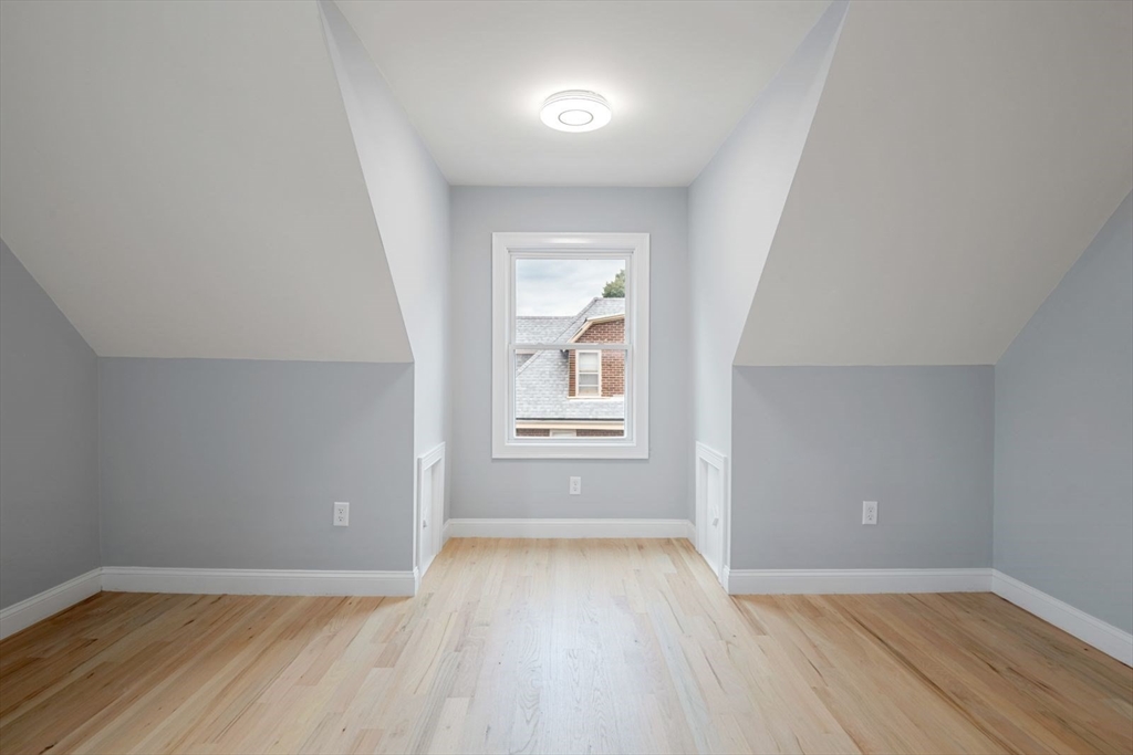 7 Waumbeck Street, Unit 2 Boston, MA 02121 - Photo 10 of 18 an empty room with wooden floor and windows