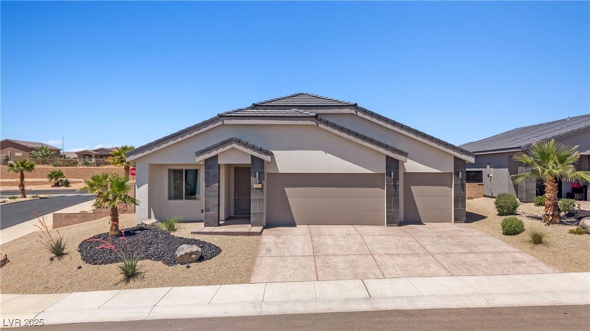 1357 Manassas Ridge Mesquite, NV 89027 - Photo 61 of 72 Ranch-style home with a garage, driveway, stucco siding, and a tile roof