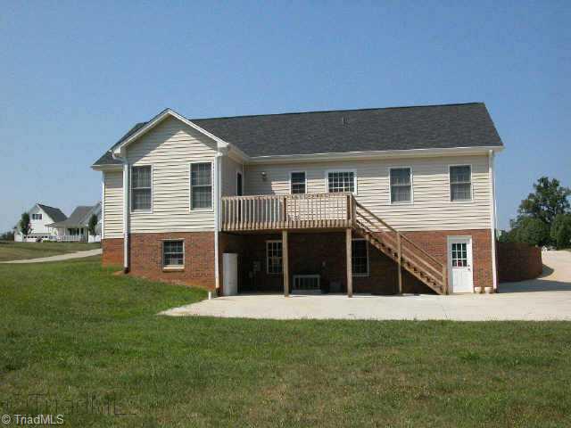 1040 Woodbury Road King, NC 27021 - Photo 3 of 9 Other. Back showing large deck & huge concrete patio.