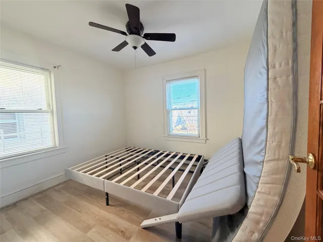 a living room with a bed furniture and a window
