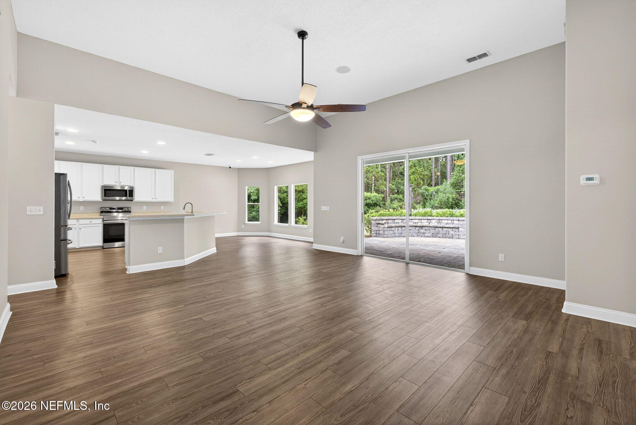 85667 Berryessa Way Fernandina Beach, FL 32034 - Photo 8 of 39 a view of a kitchen with a stove wooden floor a kitchen view and a window
