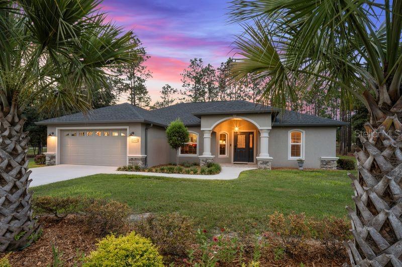 12929 Southwest 89th Street Dunnellon, FL 34432 - Photo 1 of 76 a front view of a house with a yard and garage