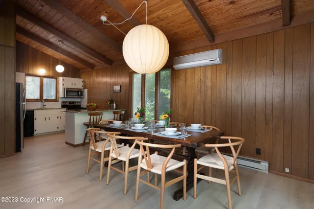 a view of a dining room with furniture and wooden floor