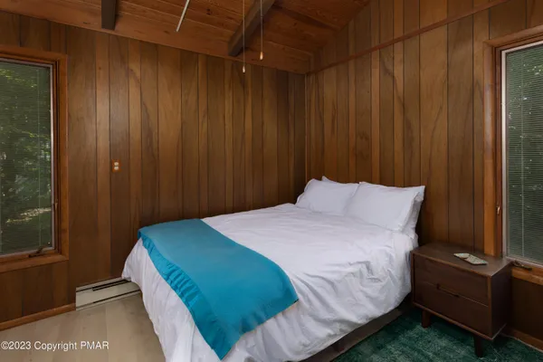 a bedroom with a bed and a mirror