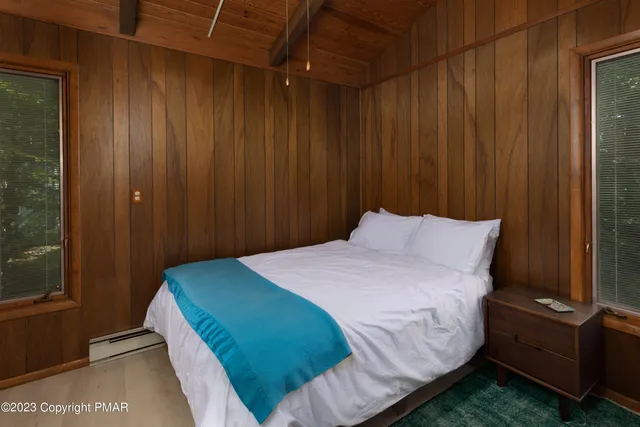 a bedroom with a bed and a mirror