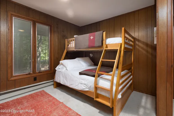 a bed sitting in a room next to a window