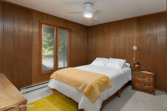 a bedroom with a bed and a night stand