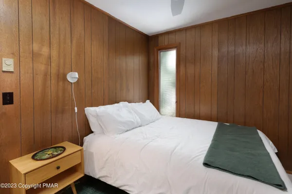 a bedroom with a bed and a night stand