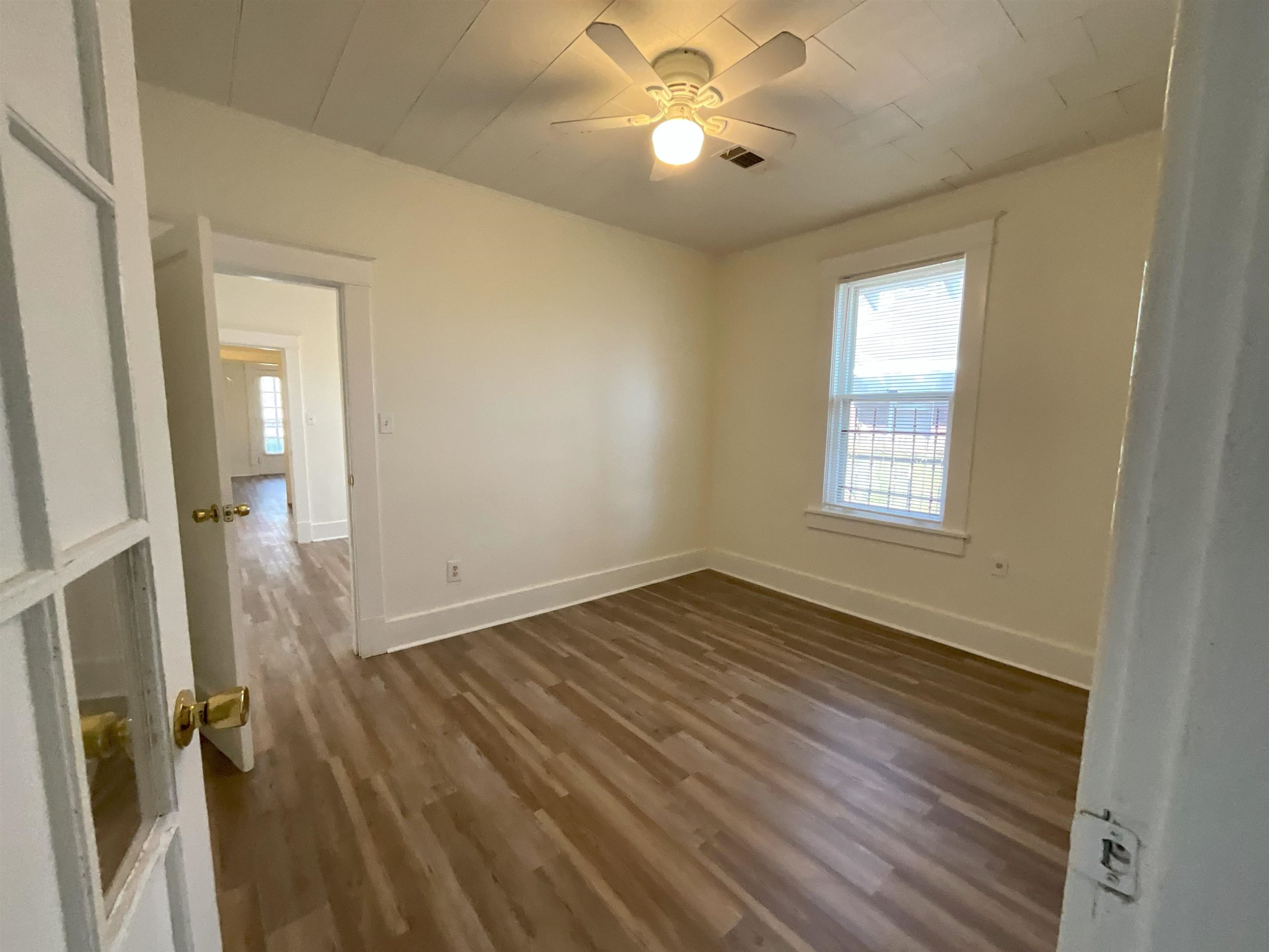 736 North Watkins Street Memphis, TN 38107 - Photo 5 of 14 wooden floor in an empty room with a window