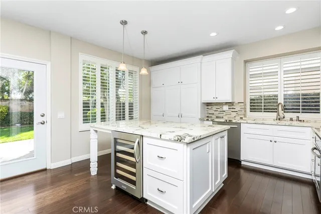 a kitchen with a stove window and cabinets