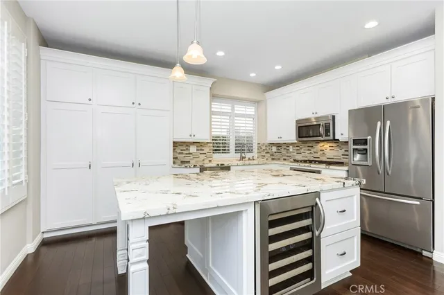 a kitchen with kitchen island cabinets and refrigerator