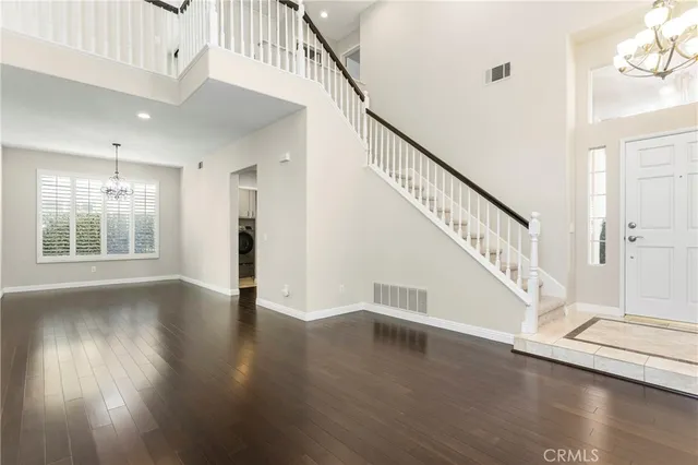 a view of an entryway with wooden floor windows and a living room