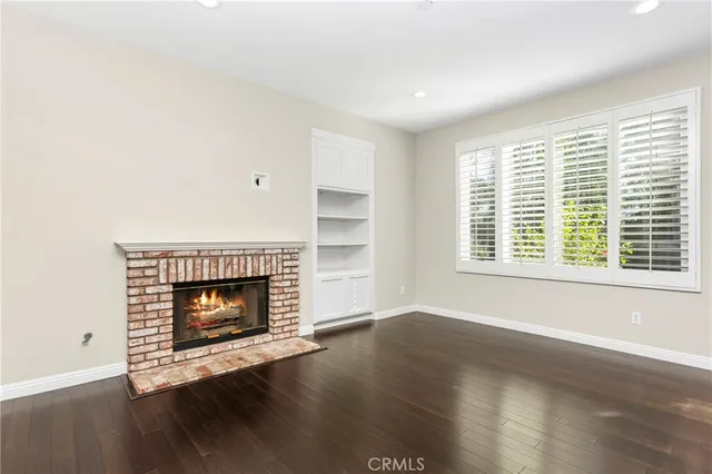 a living room with a fireplace with wooden floor