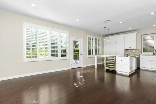 a view of a kitchen with furniture and wooden floor