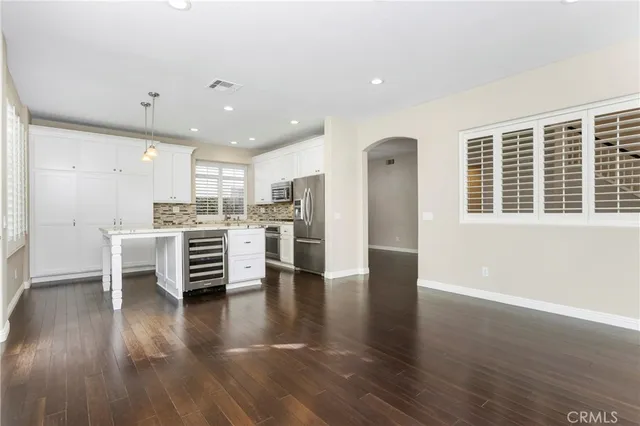 a view of kitchen with stainless steel appliances refrigerator microwave and stove
