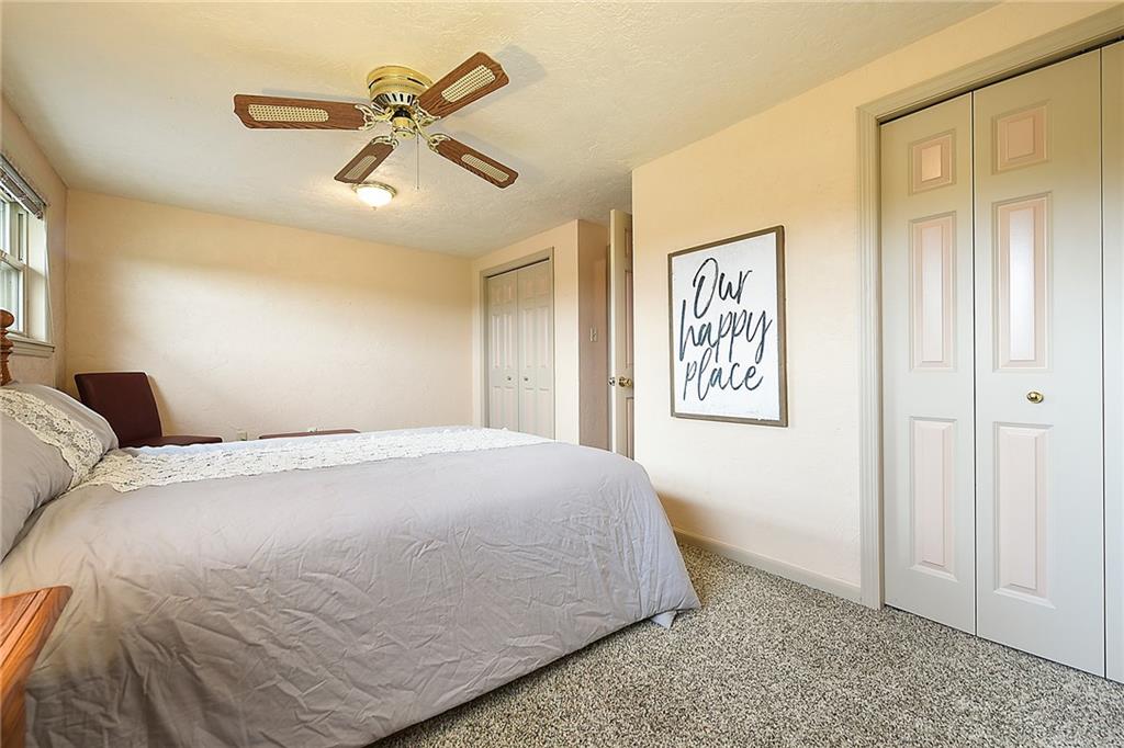 38 Manor Road Donora, PA 15033 - Photo 12 of 25 a spacious bedroom with a bed and a ceiling fan