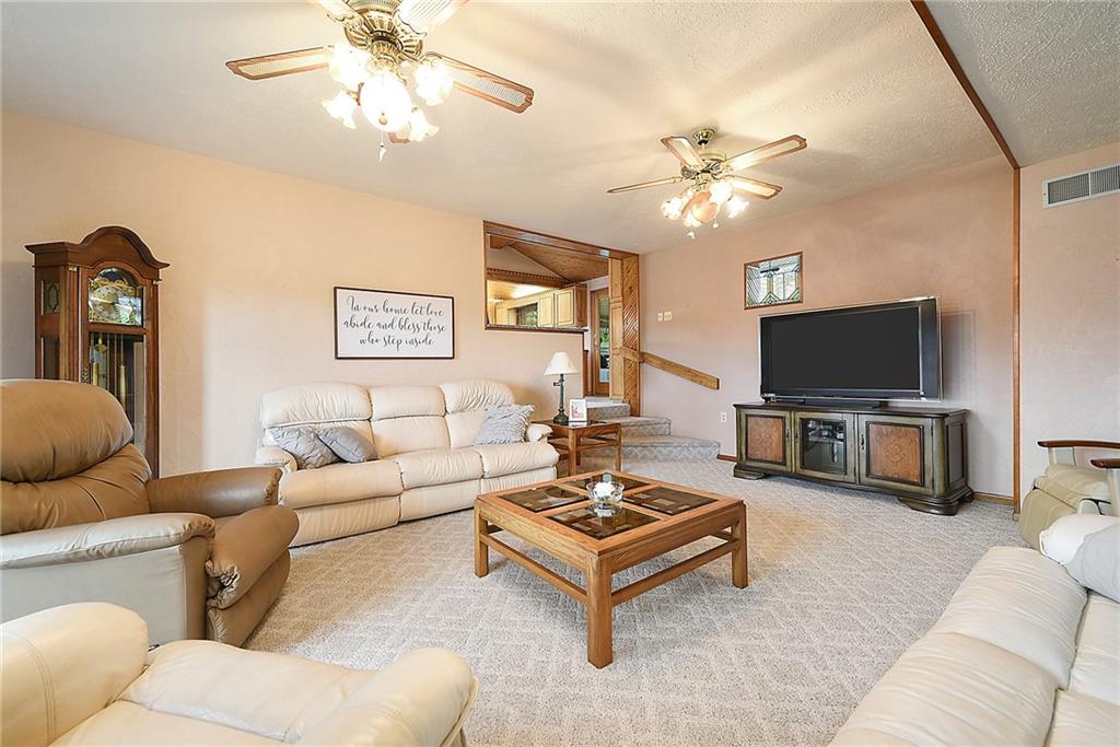 38 Manor Road Donora, PA 15033 - Photo 3 of 25 a living room with furniture a flat screen tv and a chandelier
